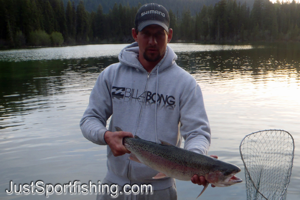 Fisherman holding a rainbow trout.