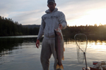 fisherman holding two big rainbow trout photo