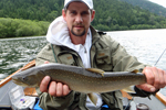 Fisherman holding a bull trout photo