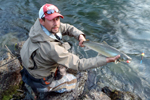 Fisherman with bull trout photo