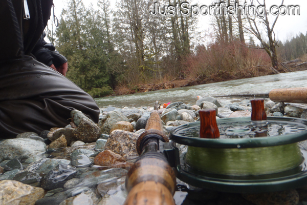 Flyfishing rod laying at the rivers edge.