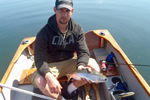 fisherman in boat with rainbow trout photo