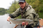 Fisherman with big rainbow trout photo