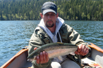 Fisherman holding a rainbow trout photo