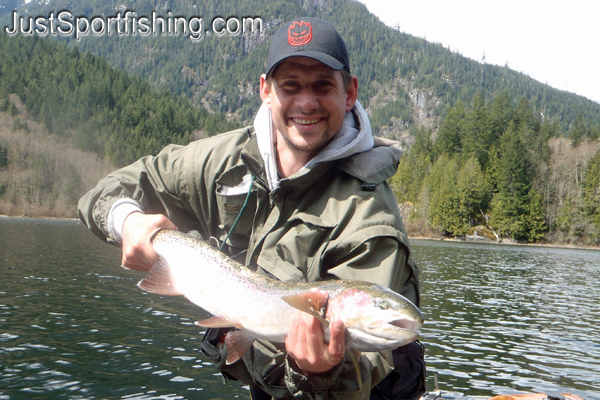 Fisherman holding a big steelhead trout.