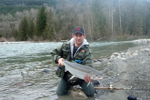 fisherman with steelhead trout photo