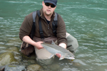 fisherman with steelhead trout photo