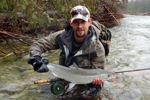 fisherman with steelhead trout photo