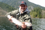 fisherman with steelhead trout photo