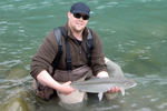 fisherman holding a steelhead trout photo